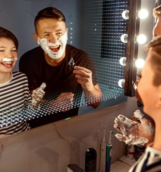 bad dad jokes - dad and son look in the mirror and laugh. dad shaves, son jokes with shaving foam
